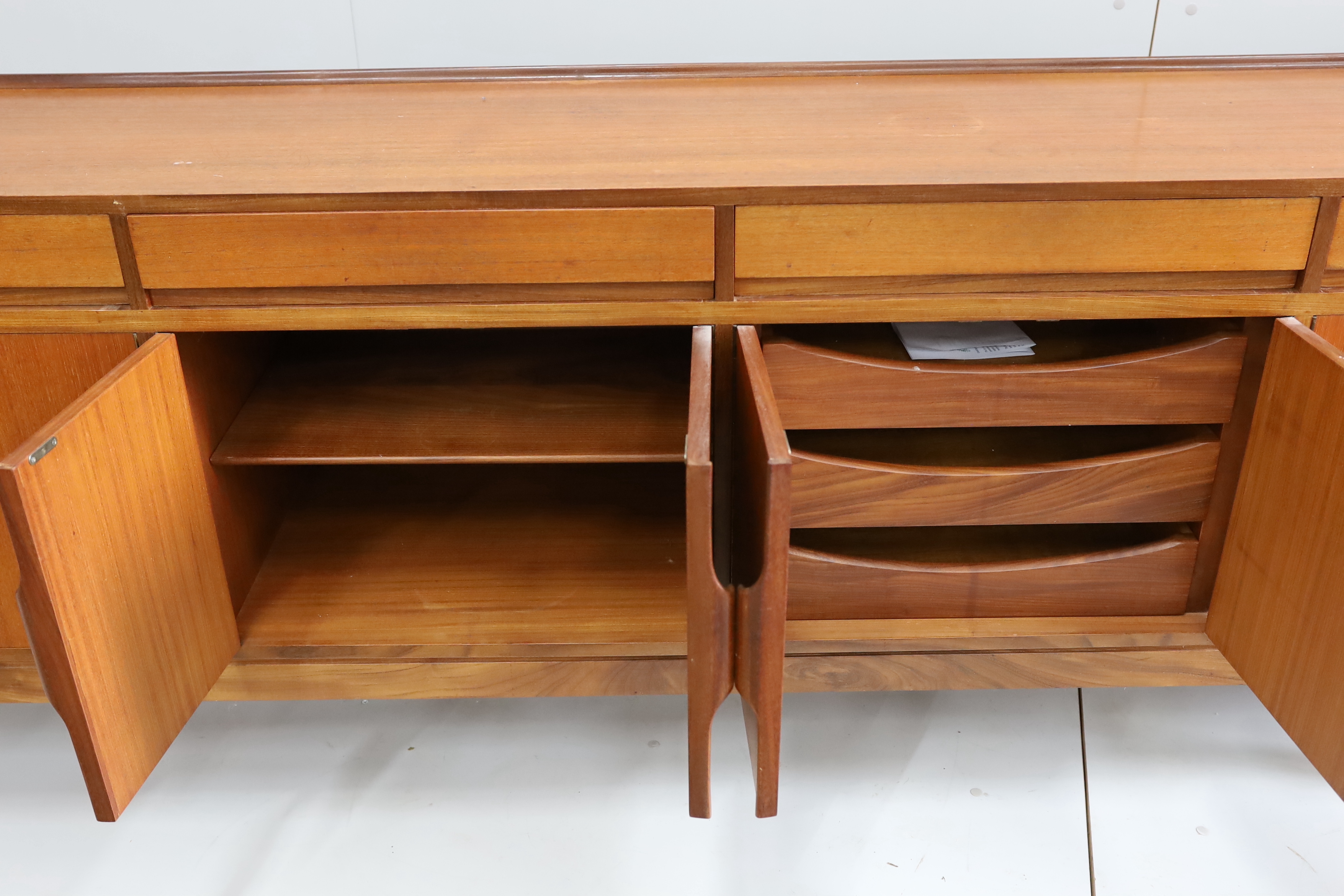 Robert Heritage for Archie Shine, a mid century teak sideboard, length 238cm, depth 46cm, height 86cm